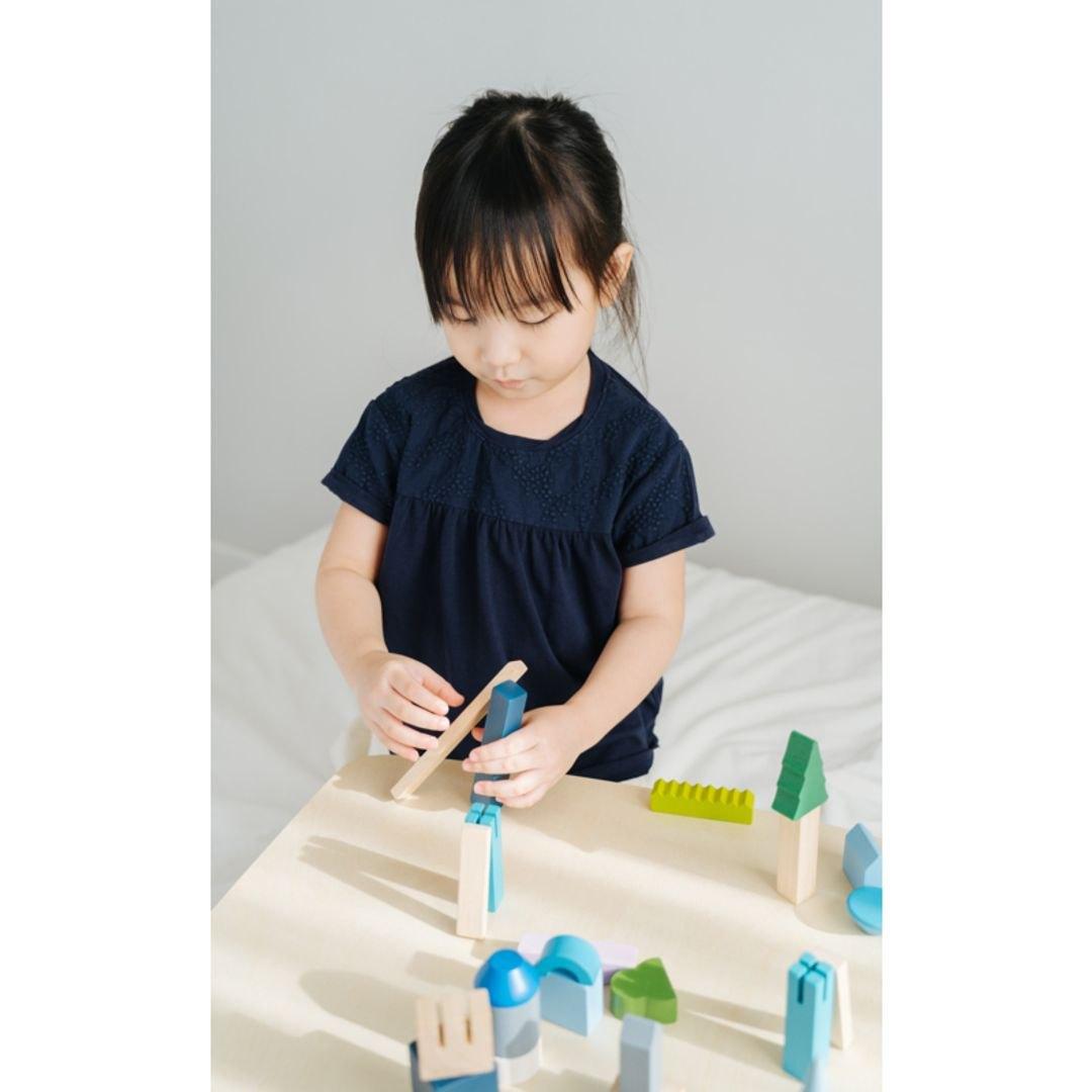 A child building with the city blocks set