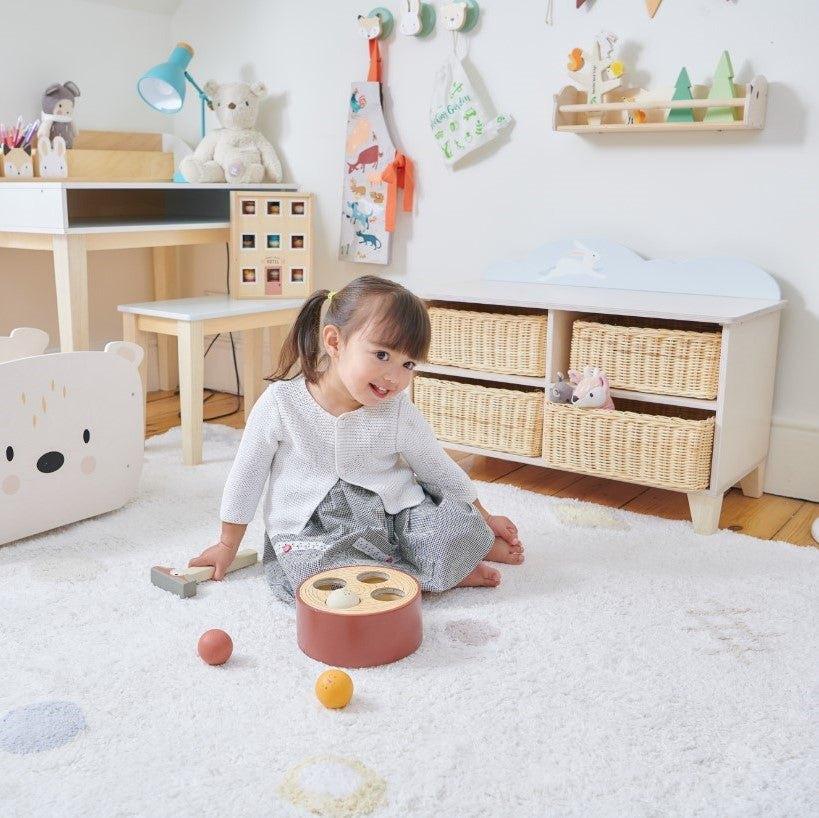 A toddler playing on a playroom rug